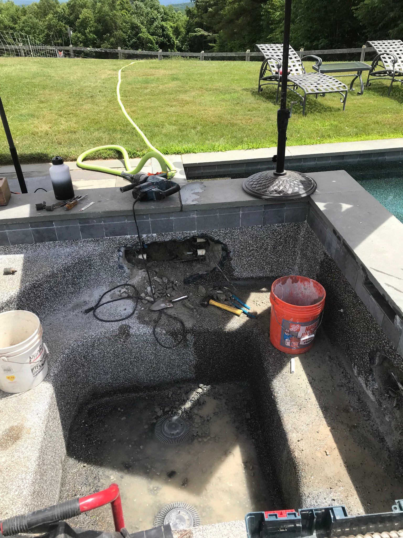 Drained spa with tools and equipment during active plumbing repair