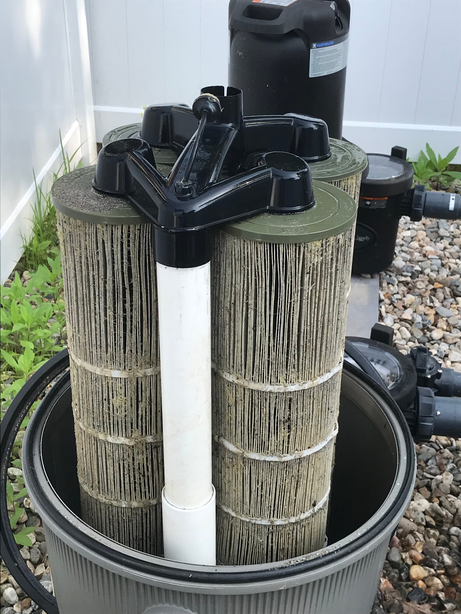 Dirty pool cartridge filters removed for cleaning and inspection