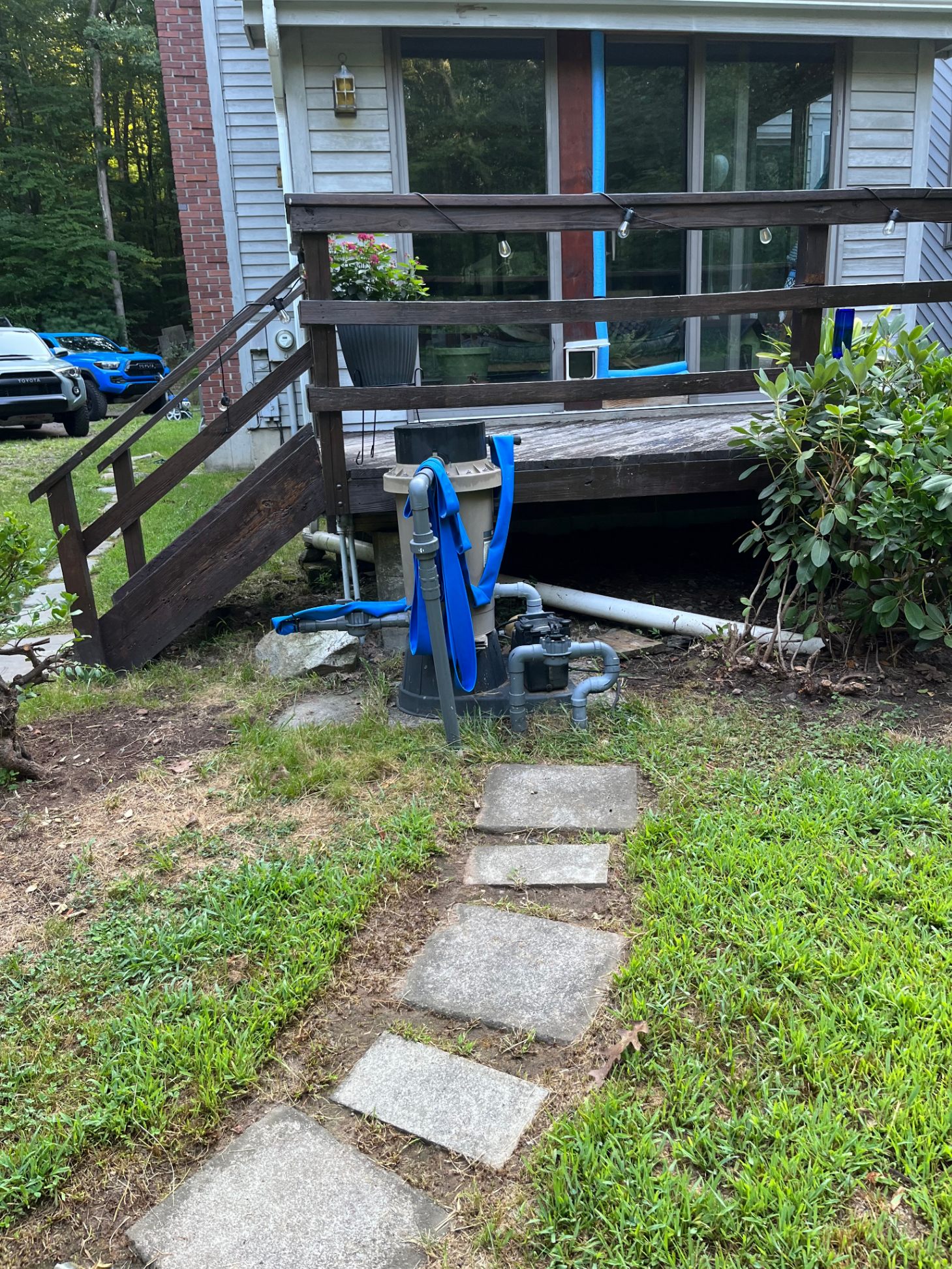 Old failing pool filter and pump setup before equipment replacement